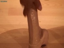 Pretty ladyboy riding a big dildo on floor