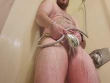 FTM transman se masturba con un gran clítoris T Dick usando el cabezal de ducha